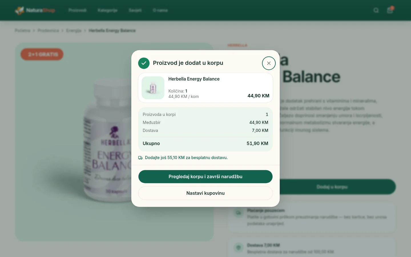 NaturaShop confirmation dialog after adding a product to the cart, listing the product, quantity, subtotal, delivery cost and total, a prompt about free delivery, and buttons to view the cart or keep shopping